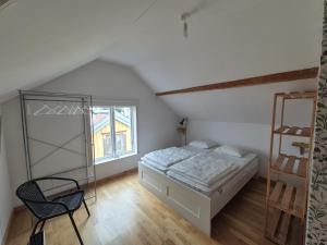 a bedroom with a bed and a ladder at Lägenhet-vindsvåning i centrala öregrund in Öregrund