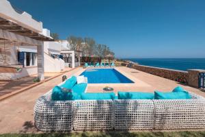 a villa with a swimming pool and a couch at Villa Domus Alba B in Portocolom