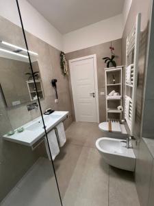 a bathroom with a sink and a toilet and a mirror at Annunziatella Suite & Rooms in Matera +34 photos
