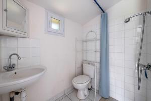 a white bathroom with a toilet and a sink at Villa de charme classée à Tharon Plage pour 14 in Tharon-Plage +31 photos