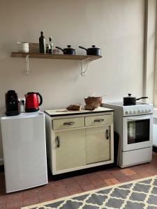 a kitchen with a stove and a refrigerator at Rural House near Sancerre 2 bedrooms in Feux