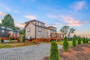 a large house with a porch and a deck at Sojourn Lodging in Sevierville