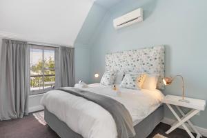 a bedroom with a large bed and a window at Winelands Golf Lodges 40 in Stellenbosch +47 photos