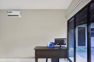 a desk with a computer on it in a room at Dancenter Juma Ciger Hotel Medan in Medan +21 photos