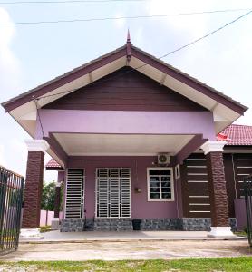 a small house with a purple at ZIYA Homestay in Jertih