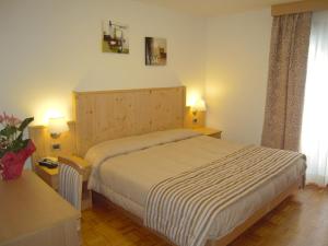 Postel nebo postele na pokoji v ubytování Miramonti Hotel
