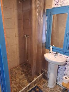 a bathroom with a shower and a sink at Casuta bunicilor Breb in Breb +54 photos