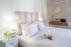 a bedroom with a bed with a tray of food on it at Georgia Villas in Skiathos