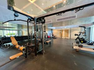 a gym with cardio equipment in a large room at Stylish Studio in Mayan 2, Yas Island in Abu Dhabi