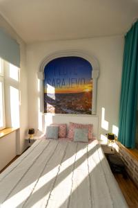 a bedroom with a large bed with a window at KIZZ Apartment in Sarajevo