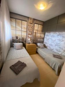 a bedroom with two beds and a large window at Amazing Sea View! in Isla Plana