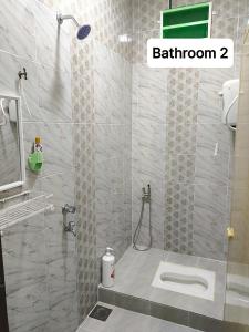 a bathroom with a shower and a toilet at ZIYA Homestay in Jertih +25 photos