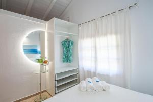 a white room with a mirror and two pairs of shoes at Georgia Villas in Skiathos