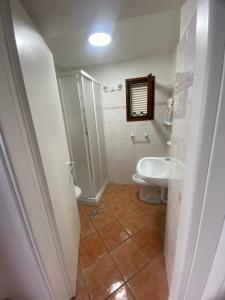 a bathroom with a toilet and a sink at Appartamenti Anna in Rio Marina +67 photos