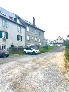 a white car parked in front of a house at Chez Ulysse studio entièrement rénové et au calme in Ussel