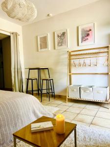 a bedroom with a bed and a candle on a table at Chez Ulysse studio entièrement rénové et au calme in Ussel