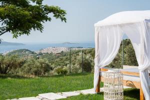a wedding ceremony in a white tent with a view at Georgia Villas in Skiathos