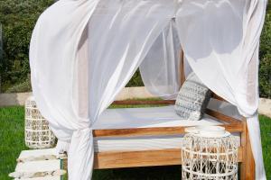a bed under a canopy with a net at Georgia Villas in Skiathos