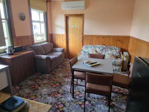 a living room with a couch and a table at Snug as a Bug Omeo in Omeo