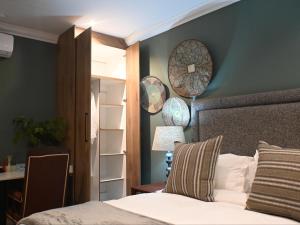 a bedroom with a bed and a table and a mirror at Waterwoods Equestrian Venue and Cottages in Nottingham Road