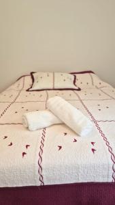 ラ・トリニテにあるT4 avec grande terrasse - BBQ - parkingのタオル2枚とチェーンが付いたベッド