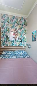 a bedroom with a bed with a painting on the wall at EnjoyCasa Tra Sole Mare e L'Etna in Adrano