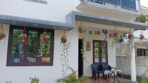a house with potted plants on the porch at Phoenix Odayam in Kappil