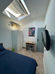 a bedroom with a bed and a desk and a skylight at Casa Elena in Eforie Sud