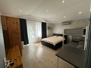 a bedroom with a bed and a desk in it at Casa Elena in Eforie Sud