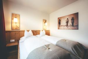 Ένα ή περισσότερα κρεβάτια σε δωμάτιο στο Quality Hosts Arlberg - Lärchenhof