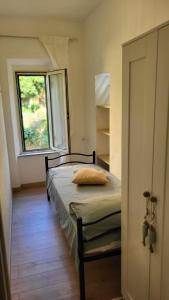a bedroom with a bed and a window in a room at Nima in Porto Santo Stefano