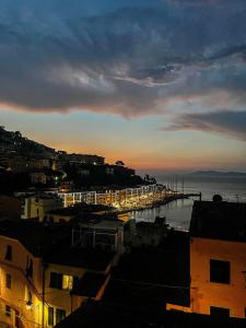 a view of a city with a pier at sunset at Nima in Porto Santo Stefano