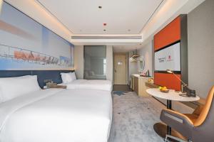 Letto o letti in una camera di Foshan Jifeng International Hotel