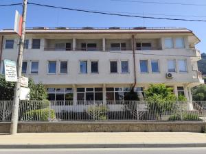 a large white building on the side of a street at Ловна хижа Мурсалица in Devin