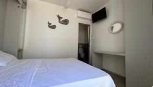 a bedroom with a bed and a clock on the wall at aMare Senigallia in Senigallia
