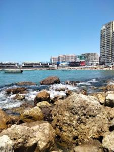 a group of rocks on the shore of the water at القاهرة in New cairo