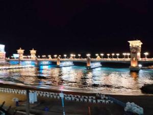 a bridge over the water at night with lights at القاهرة in New cairo