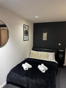 a bedroom with a bed with two white towels on it at Modern TWO Bedroom Apartment Amazing Views Birmingham City Centre FREE Underground Parking in Birmingham