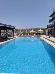 a large blue swimming pool on a building at The Mood Hotel in Gümbet +19 photos