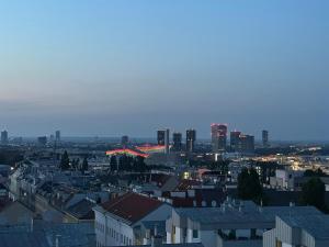 a view of a city at night with buildings at Panorama Apartments Vienna in Vienna