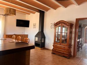 a kitchen with a wood stove in a room at Can Mariano Mayans in Sant Francesc Xavier