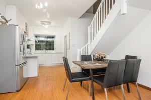 a kitchen and dining room with a table and chairs at Comfort Stay in Bankstown Free Parking in Bankstown