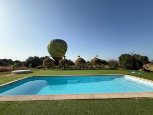 a hot air balloon and a swimming pool with a hot air balloon at Agroturismo Finca Dalt Murada in Binissalem
