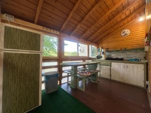 a kitchen in a log cabin with a table at Luna de miere in Cinciş