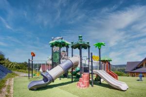 a playground with a slide in a park at Santa Angela Solina Resort & SPA in Solina