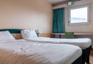 Postel nebo postele na pokoji v ubytování B&B HOTEL Grenoble Université 2