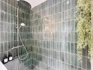 a bathroom with a shower with glass tile walls at Azur in Cagnes-sur-Mer +15 photos