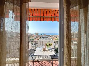 a balcony with a table and a view of the ocean at Azur in Cagnes-sur-Mer