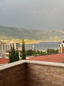 a view of the ocean from a brick wall at Apartman sa pogledom na more Budva in Budva +14 photos