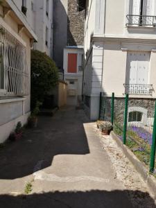 un callejón entre dos edificios con una valla en Damalix, en Saint-Maurice 6 fotos más